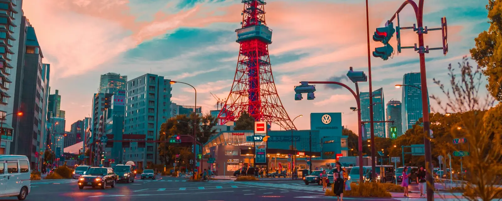 Tokyo Tower at dusk reflected in rain puddles after a passing shower