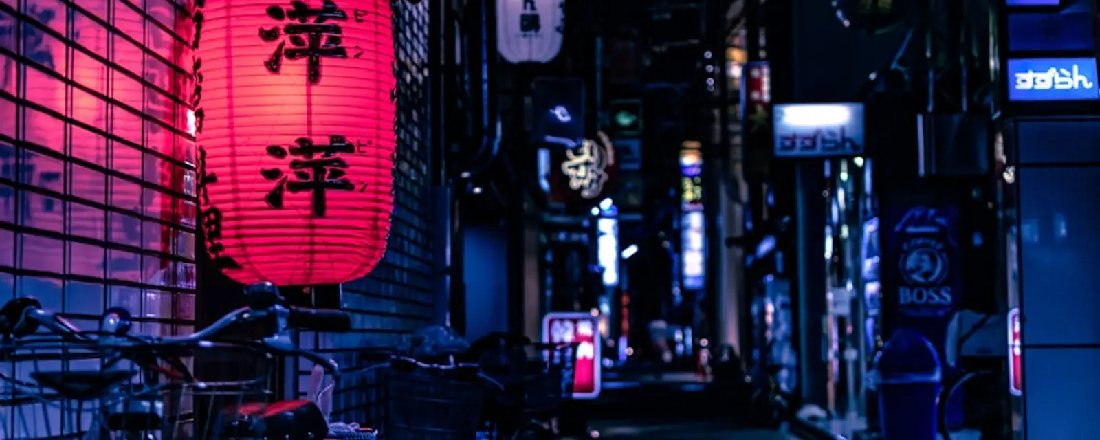 A red lantern glowing in a quiet blue-toned alley at dusk
