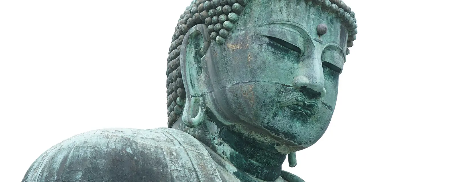The serene face of the Great Buddha of Kamakura in weathered bronze
